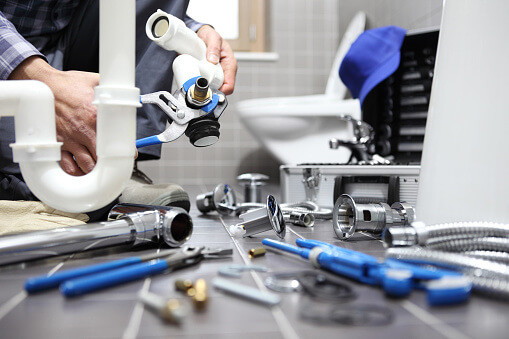 Plumber working on toilet