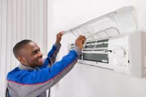 HVAC technician working on ductless unit