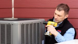 Technician performing air conditioning repair