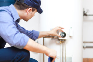 technician repairing a hot-water heater